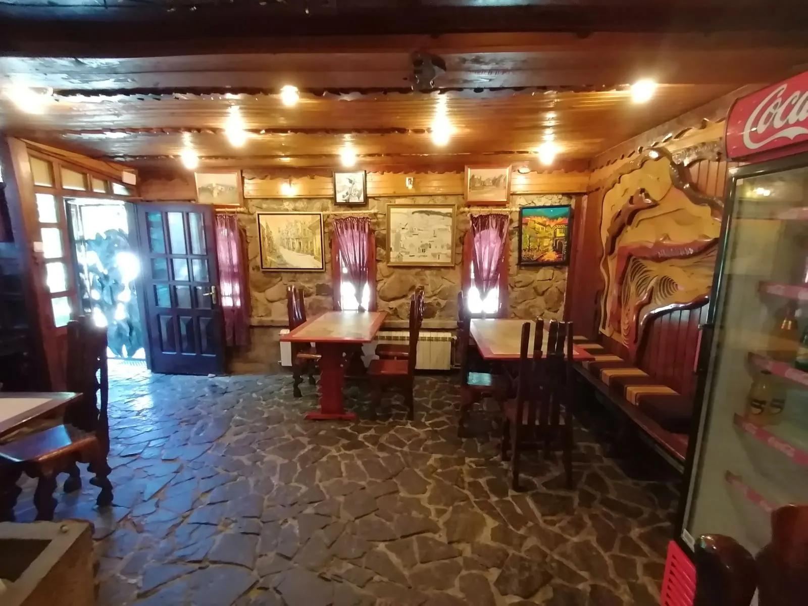 The stone room of the tavern with paintings on the walls